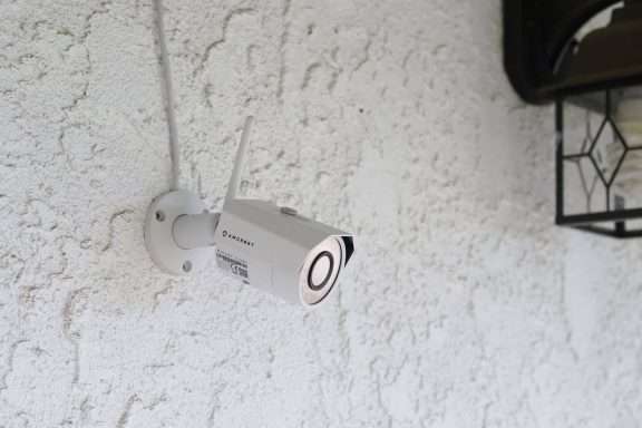 Amcrest security camera mounted to exterior wall